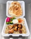 Grilled chicken kabab plate with rice, hummus, salad, pickled turnips, garlic sauce, and pita