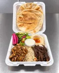 Shawarma combo plate with chicken and beef shawarma, rice, hummus, salad, and pita