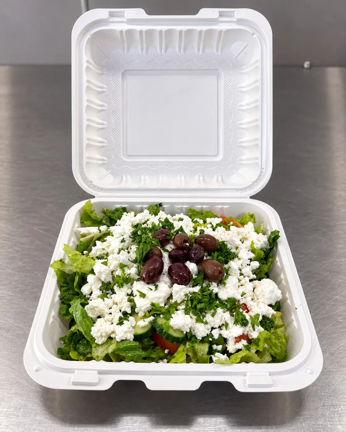 Greek salad with feta cheese, kalamata olives, cucumber, tomato, and parsley